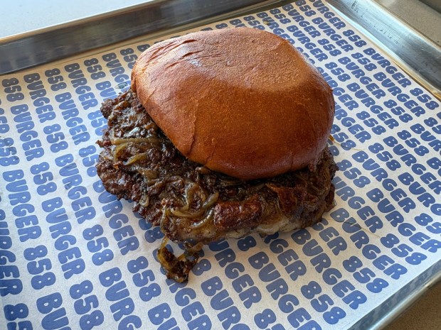858 Burger located in La Jolla serves up its namesake "858 Burger" with grilled onions and a bacon jam. (Jayne Yutig / The San Diego Union-Tribune)