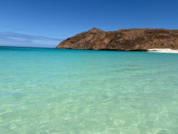 The beach at Wizard Hill features white sand that is as fine as powdered sugar. The turquoise blue waters are clear enough to spot schools of blue and yellow parrotfish. (Eleanor Yang Su)