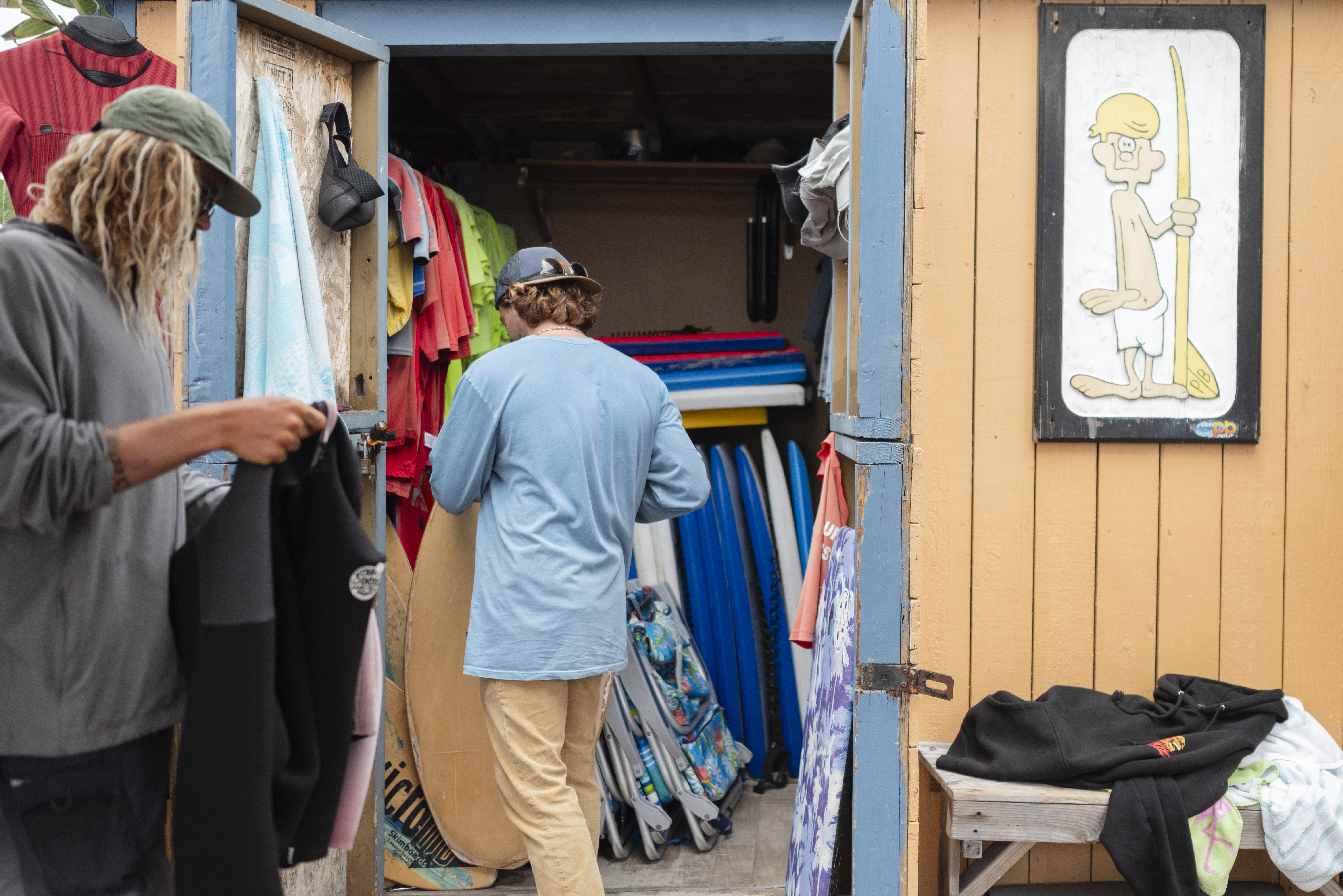 Marcos Guimaraes, left and Dylan Byrd, right organize beach gear...