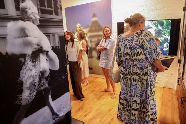 Guests look over photographs of Pop icon Marilyn Monroe, during a media night preview of Marilyn Monroe: The Defining Roles, at the Ice House Museum at the Hotel Del Coronado on Friday, May 29, 2026. The exhibit is celebrating her 100th birthday and will run from May 30th through July 31st. (Photo by Sandy Huffaker for The San Diego Union-Tribune)