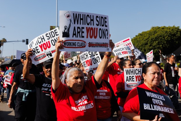 People march during a May Day protest in downtown San Diego on Friday. (Kristian Carreon / The San Diego Union-Tribune)