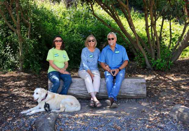 Sherry Ashbaugh, left, and Nancy and Wes Janssen of Paradise Gardeners recount the years of grant writing and volunteer work that culminated in Paradise Hills Native Garden. (K.C. Alfred / The San Diego Union-Tribune)