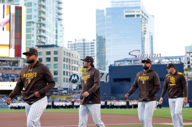 Randy Vásquez #98, Matt Waldron #61, Germán Márquez #33 and Nick Pivetta #27 of the San Diego Padres walk towards the dugout before the game against the Chicago Cubs at Petco Park on Tuesday, April 28, 2026 in San Diego, California. (Meg McLaughlin / The San Diego Union-Tribune)