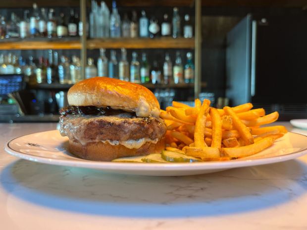 The Rare Society Signature Burger from Rare Society in University Heights is made with a Wagyu beef patty, boschetto al tartufo cheese, onion marmalade, truffle aioli and a brioche bun. (Abby Hamblin / The San Diego Union-Tribune)