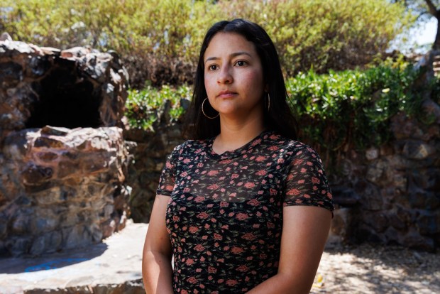 Itzel Maganda Chavez poses at Golden Hill Fountain Grotto near where she lives on Wednesday, May 20, 2026. Chavez, 32, is one of the people campaigning for Measure A.
