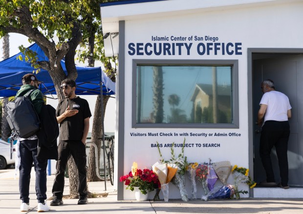 San Diego, CA - A security guard speaks with a community member in front of the recently funded security center at the San Diego Islamic Center in San Diego on Friday, May 22, 2026. (Luke Johnson / The San Diego Union-Tribune)
