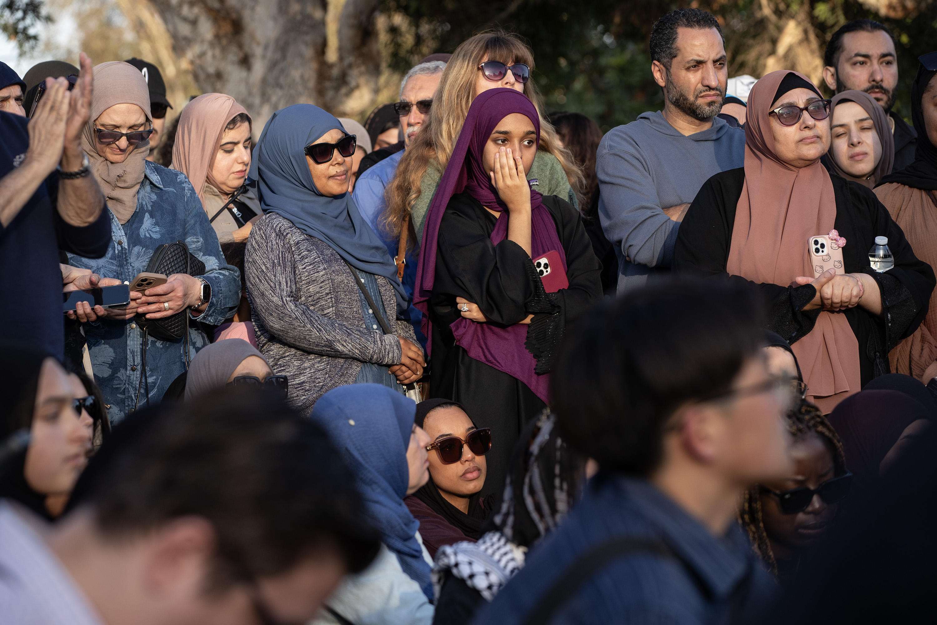 San Diego, CA – People react to speakers during an...