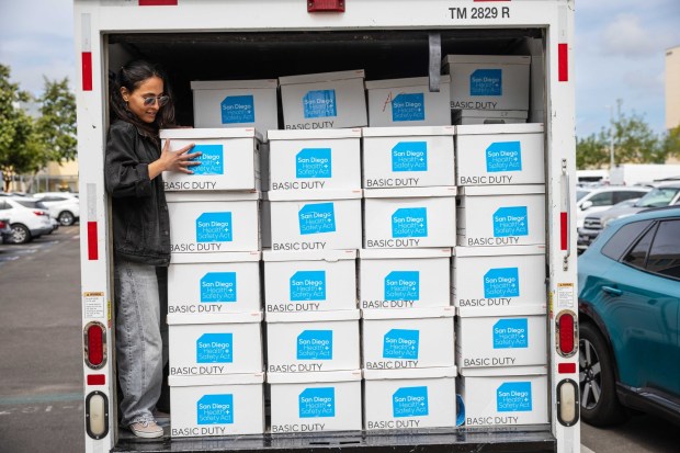 Natalia Rodriguez moves boxes with signatures for a ballot measure for a half-cent sales tax increase in San Diego County to fund health and safety initiatives on Monday, May 4, 2026, in San Diego. (Zoë Meyers / For The San Diego Union-Tribune)