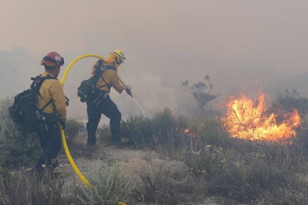 Firefighters battle the Tusil fire on I-8 as it burns on both sides of I-8 on Tuesday, May 19, 2026 near Campo, CA. (Michael Ho / For The San Diego Union-Tribune)