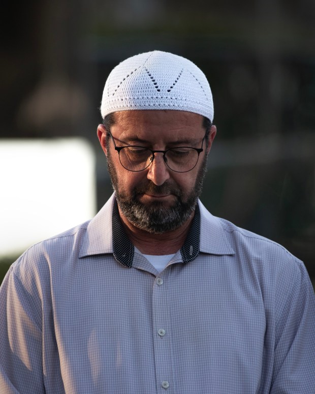 San Diego, CA - Imam Taha Hassane of the Islamic Center of San Diego listens to other speakers during an evening vigil in front of Geisel Library at UCSD on Wednesday, May 20, 2026, in San Diego, CA. (Luke Johnson / The San Diego Union-Tribune)