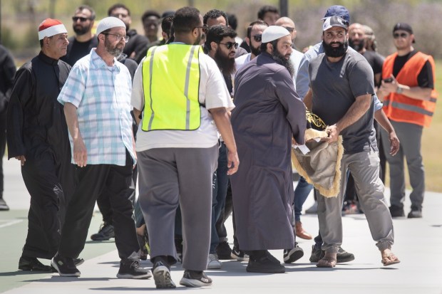 San Diego, CA - Family members of the deceased carry their bodies to the front of the crowd as people gather for the Janazah Prayer at Mission Valley River Park on Thursday, May 21, 2026, in San Diego, CA. The prayer is in remembrance of the three men, Amin Abdullah, Mansuor Kaziha and Nadir Awad, who were slain protecting the community at the San Diego Islamic Center on Monday, May 18. (Luke Johnson / The San Diego Union-Tribune)