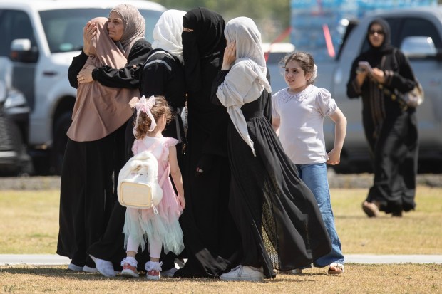 San Diego, CA - A group embraces as people gather for the Janazah Prayer at Mission Valley River Park on Thursday, May 21, 2026, in San Diego, CA. The prayer is in remembrance of the three men, Amin Abdullah, Mansuor Kaziha and Nadir Awad, who were slain protecting the community at the San Diego Islamic Center on Monday, May 18. (Luke Johnson / The San Diego Union-Tribune)