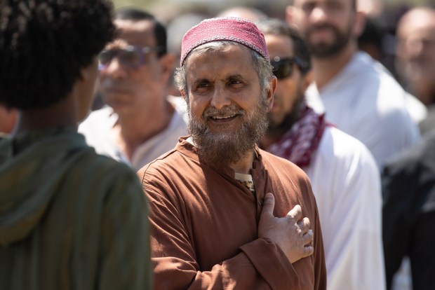 San Diego, CA - A man guides people as they gather for the Janazah Prayer at Mission Valley River Park on Thursday, May 21, 2026, in San Diego, CA. The prayer is in remembrance of the three men, Amin Abdullah, Mansour Kaziha and Nadir Awad, who were slain protecting the community at the San Diego Islamic Center on Monday, May 18. (Luke Johnson / The San Diego Union-Tribune)