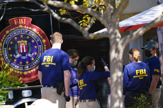 Investigators gather outside the home of Larry and Maya Millete on Oct. 19, 2021. (Nelvin C. Cepeda / U-T file)