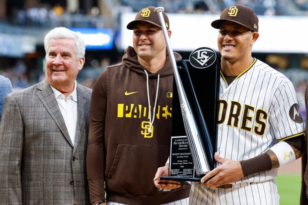 Erik Greupner, Chairman John Seidler, Craig Stammen, and Manny Machado #13, and Steven Souza Jr. pose for a photo after Machado was presented with a Louisville Silver Slugger Award before their game Colorado Rockies at Petco Park on Thursday, April 9, 2026 in San Diego, California. (Meg McLaughlin / The San Diego Union-Tribune)