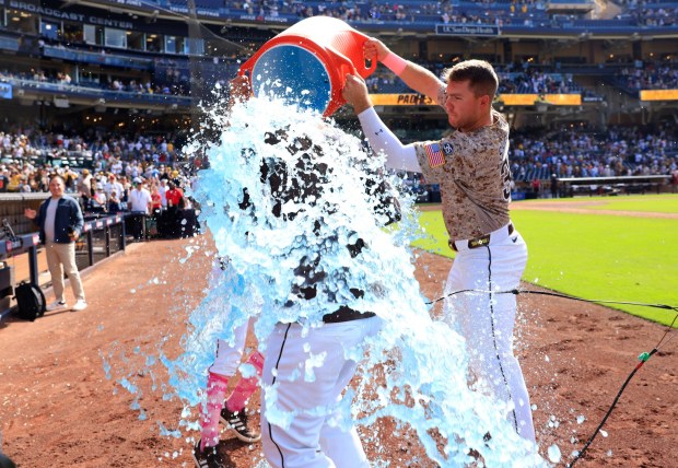 Nick Castellanos #21 of the San Diego Padres is dunked by Gavin Sheets #30 after a 3-2 win against the St. Louis Cardinals at Petco Park on May 10, 2026 in San Diego, CA. (K.C. Alfred / The San Diego Union-Tribune)