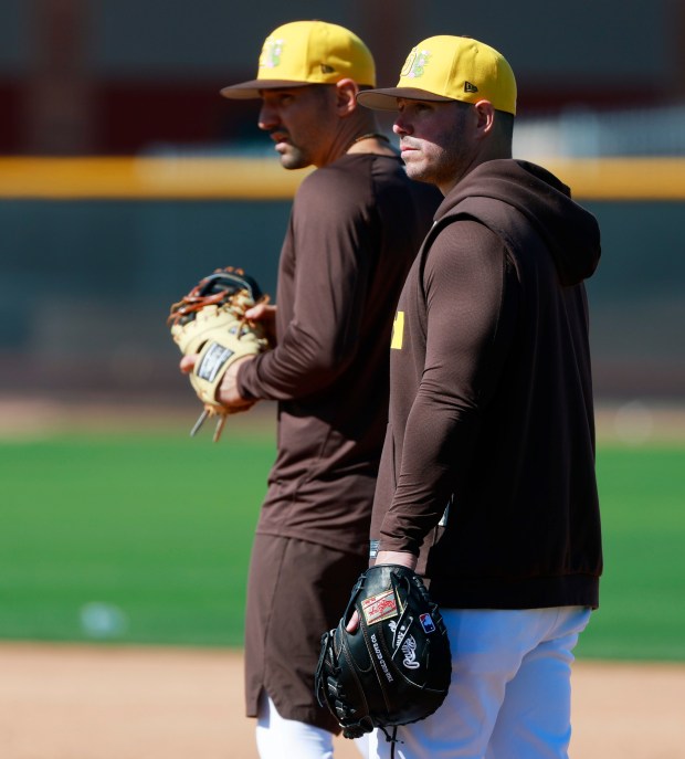 Nick Castellanos and Ty France of the San Diego Padres work out at first base during a spring training practice on February 19, 2026 in Peoria, AZ. (K.C. Alfred / The San Diego Union-Tribune)