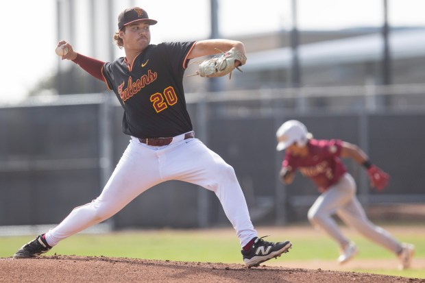 Torrey Pines' Josh Sisson pitches as the Falcons take on the Mission Hills on Friday at Torrey Pines High School. Mission Hills beat Torrey Pines, 12-8. (Luke Johnson / The San Diego Union-Tribune)