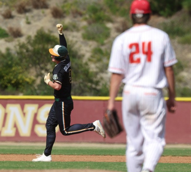 Patrick Henry's Jayden Goldman pumps his fist while running the bases after he hit a two-run home run as Cathedral Catholic's pitcher Kaden Kuhn walks back to the mound in the first inning of the CIF Open Division semifinal playoff game at Cathedral Catholic High School in San Diego on Tuesday, May 26, 2026. (Hayne Palmour IV / For The San Diego Union-Tribune)
