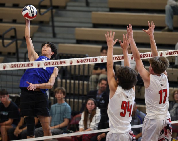 Eastlakexe2x80x99s Alan Ebert hits the ball toward the net as Canyon Crest Academyxe2x80x99s Matthew White, left, and Odin Paterson try to block in the first set during the CIF Division I prep boys volleyball championship at Mission Hills High School in San Marcos on Friday, May 15, 2026. (Hayne Palmour IV / For The San Diego Union-Tribune)