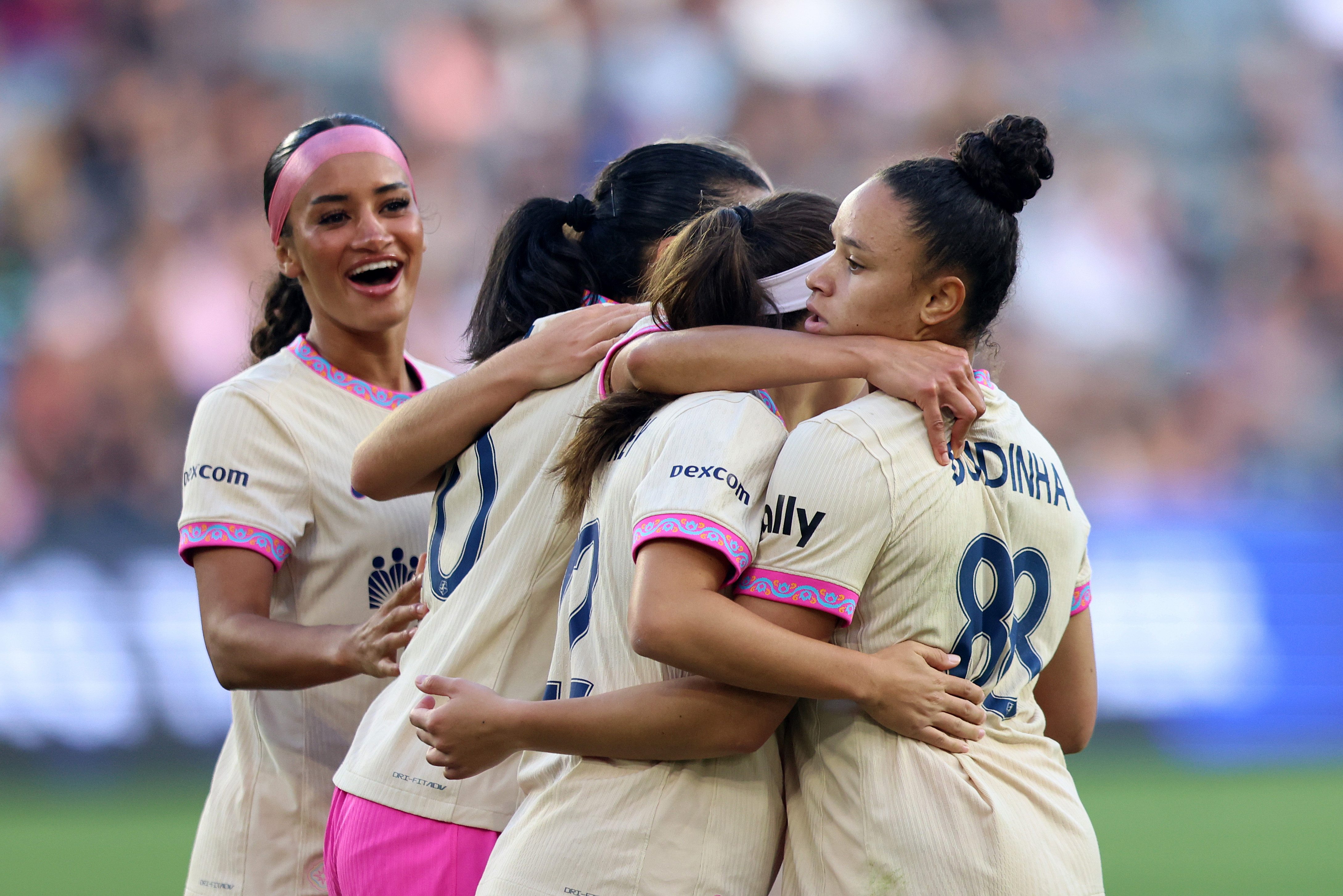 Dudinha and her San Diego Wave FC teammates celebrate her...