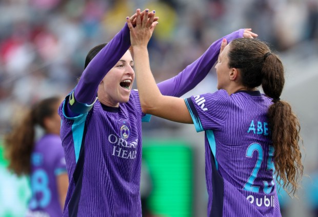 The Orlando Pride's Kerry Abello, right, and Haley McCutcheon celebrate the Pride's 1-0 victory over the Wave at Snapdragon Stadium in San Diego on Sunday, May 24, 2026. (Hayne Palmour IV / For The San Diego Union-Tribune)