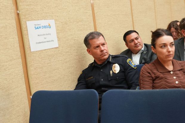 San Diego Police Chief Scott Wahl, left, looks on as members of the public complain about budget plans for the San Diego Police Department at a budget hearing at City Hall on Wednesday, May 27, 2026. (Michael Ho / For The San Diego Union-Tribune)
