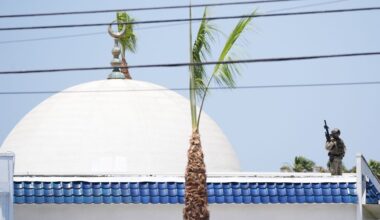 Police stage on a roof at the scene of a shooting outside the Islamic Center of San Diego Monday, May 18, 2026, in San Diego. (AP Photo/Gregory Bull)