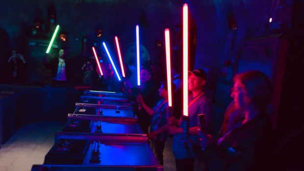 Builders illuminate their hand-built lightsabers in Savi's Workshop at Star Wars: Galaxy's Edge in Disneyland. (Brady MacDonald/Orange County Register)
