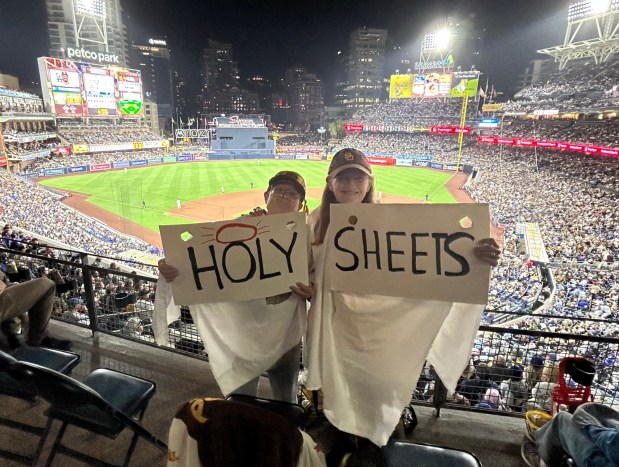 Sheryl Smith (left) and Denise Nelesen salute the Padres' Gavin Sheets. (Kirk Kenney / San Diego Union-Tribune)