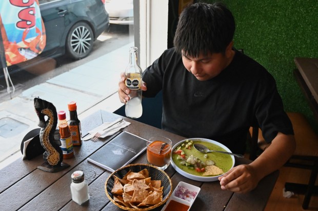 Melvin Andres from San Diego, who is a friend of Francisco Duarte's daughter, Araceli, came to support his family's restaurant while also trying the new seafood place that he recently opened, a Sonora Mexican style seafood restaurant called "Mariscos 4 Hermanos" (Seafood 4 Siblings) in Tijuana, Mexico on Friday, May 8, 2026. Duarte lived in National City, California for more than 30 years and worked as a paletero or ice cream street vendor, until October of last year when he was deported from the U.S. back to Mexico. (Carlos Moreno / The San Diego Union-Tribune)
