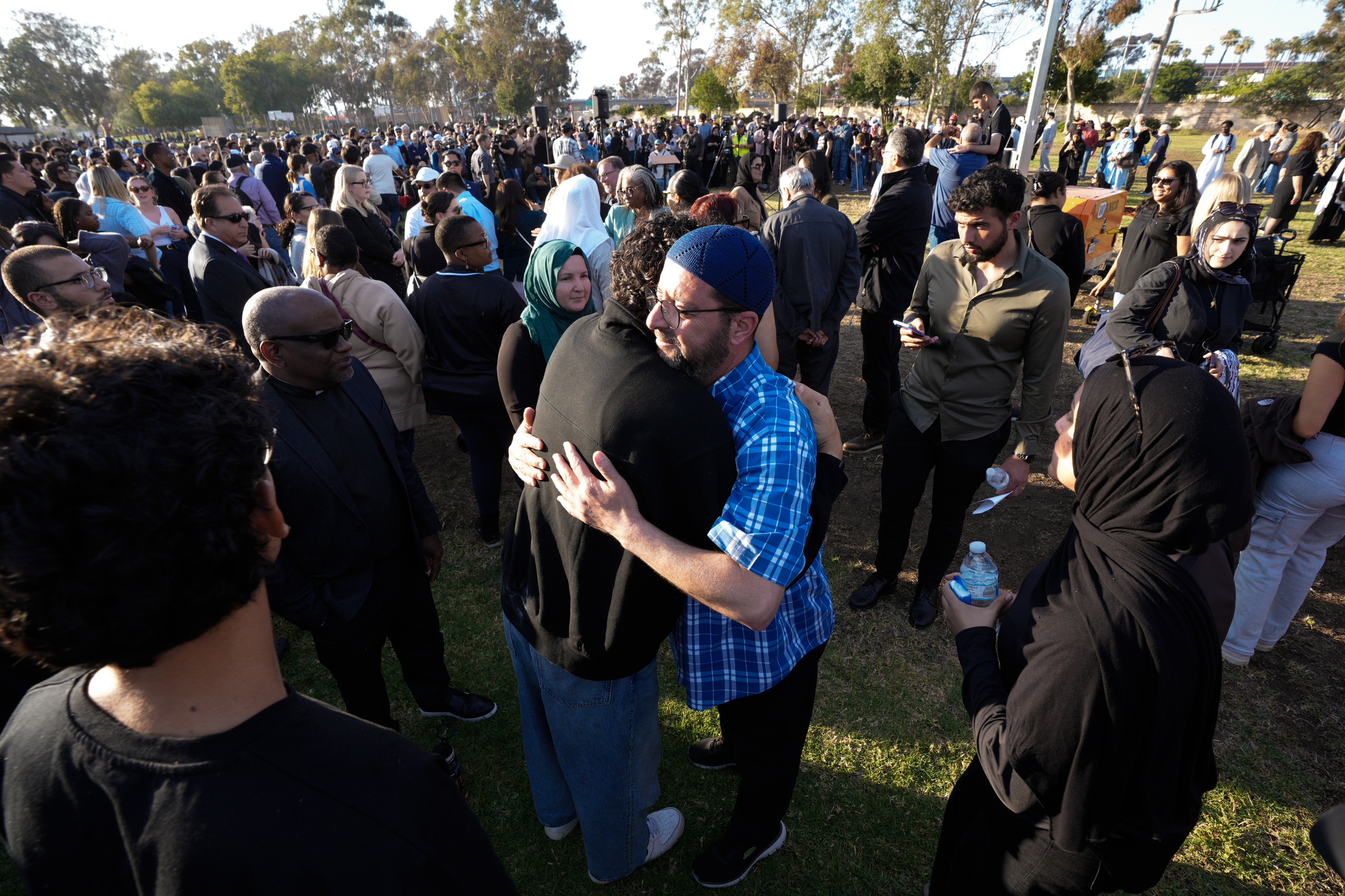 Taha Hassane, the centerâs imam is met with people who...