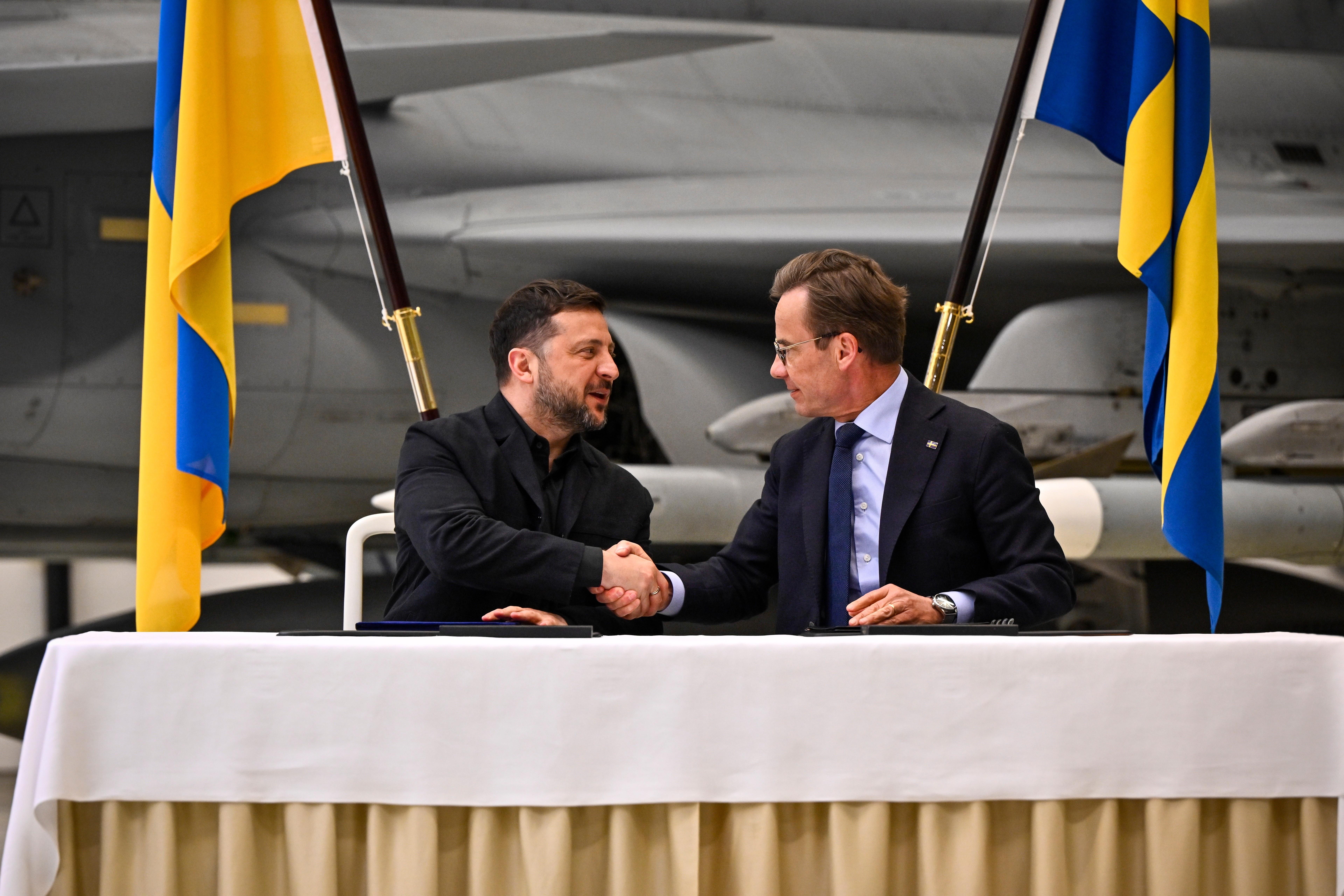 Sweden's Prime Minister Ulf Kristersson and Ukraine's President Volodymyr Zelenskyy shake hands.