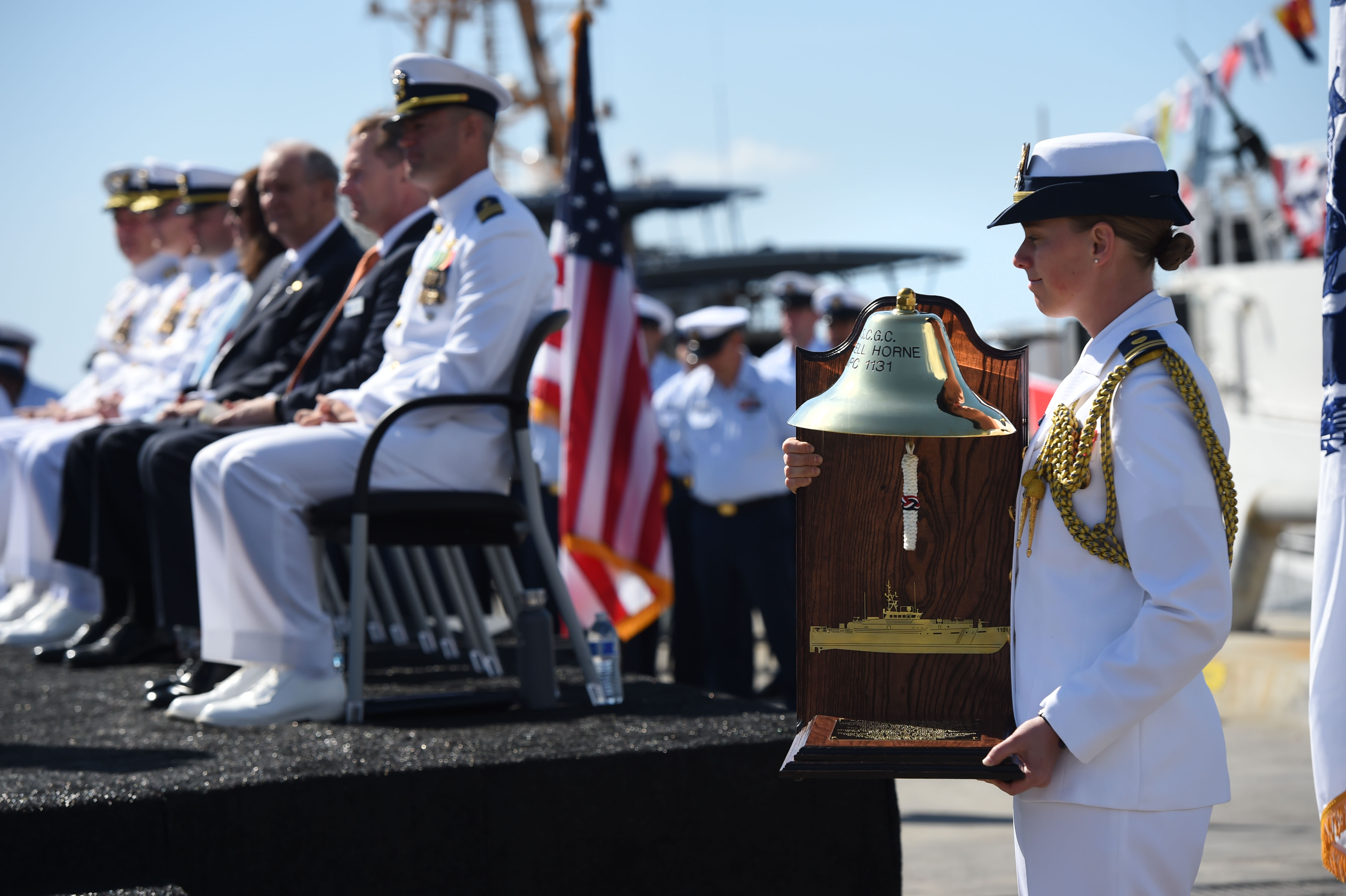 The ships bell is presented during the commissioning ceremony for...