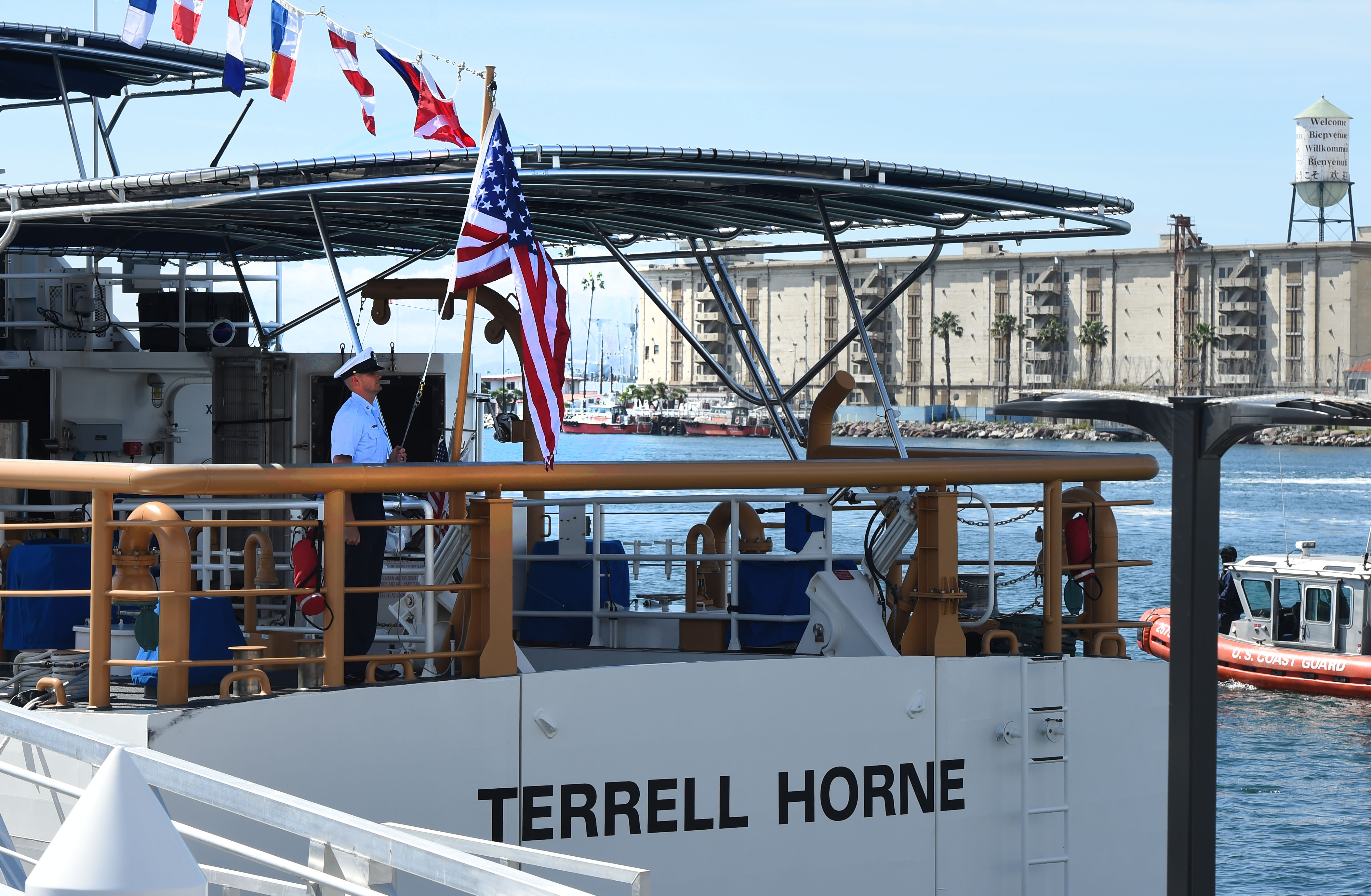 The American Flag is hoisted during the commissioning ceremony for...