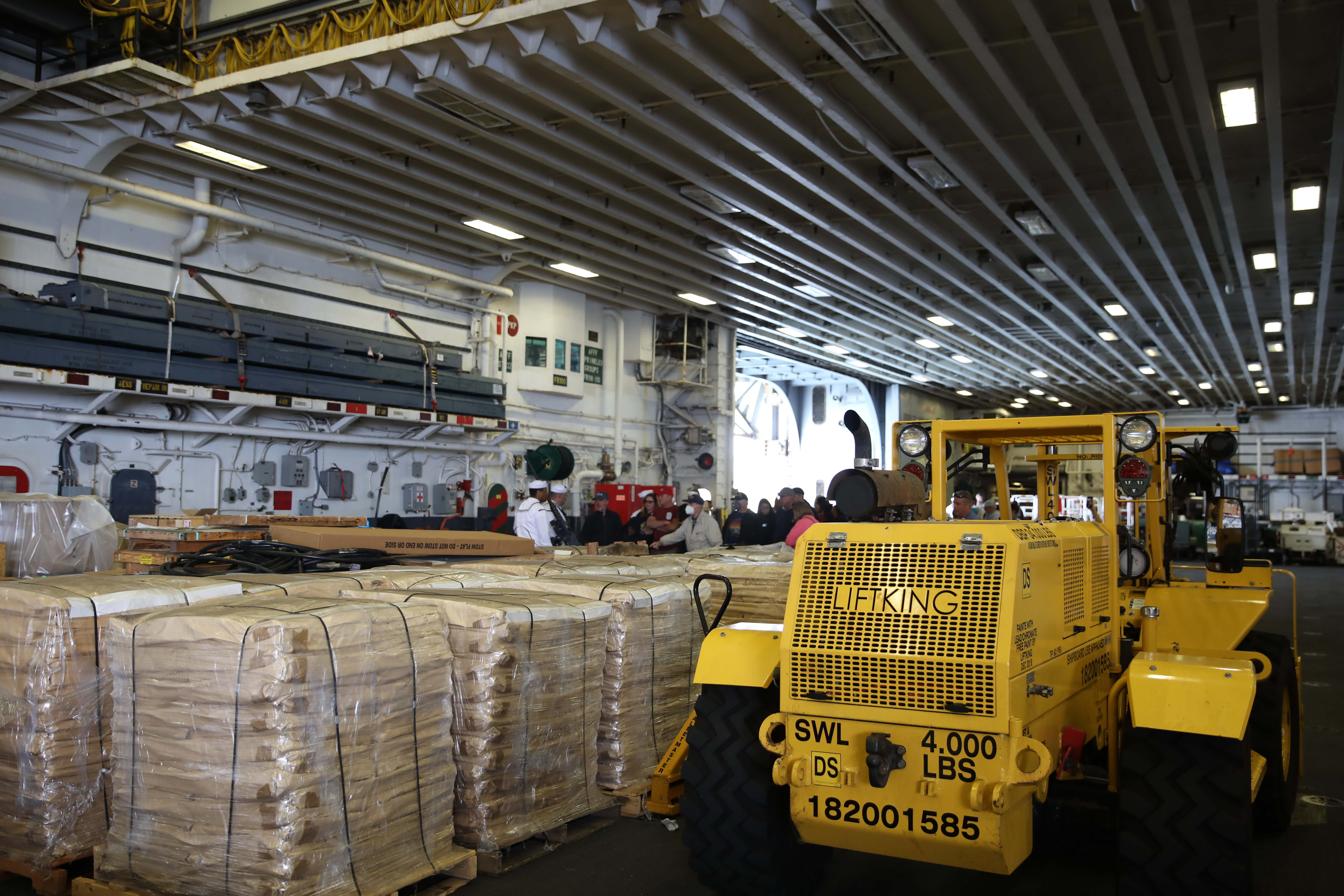 Visitors tour the Hangar Bay of the USS Essex, an...