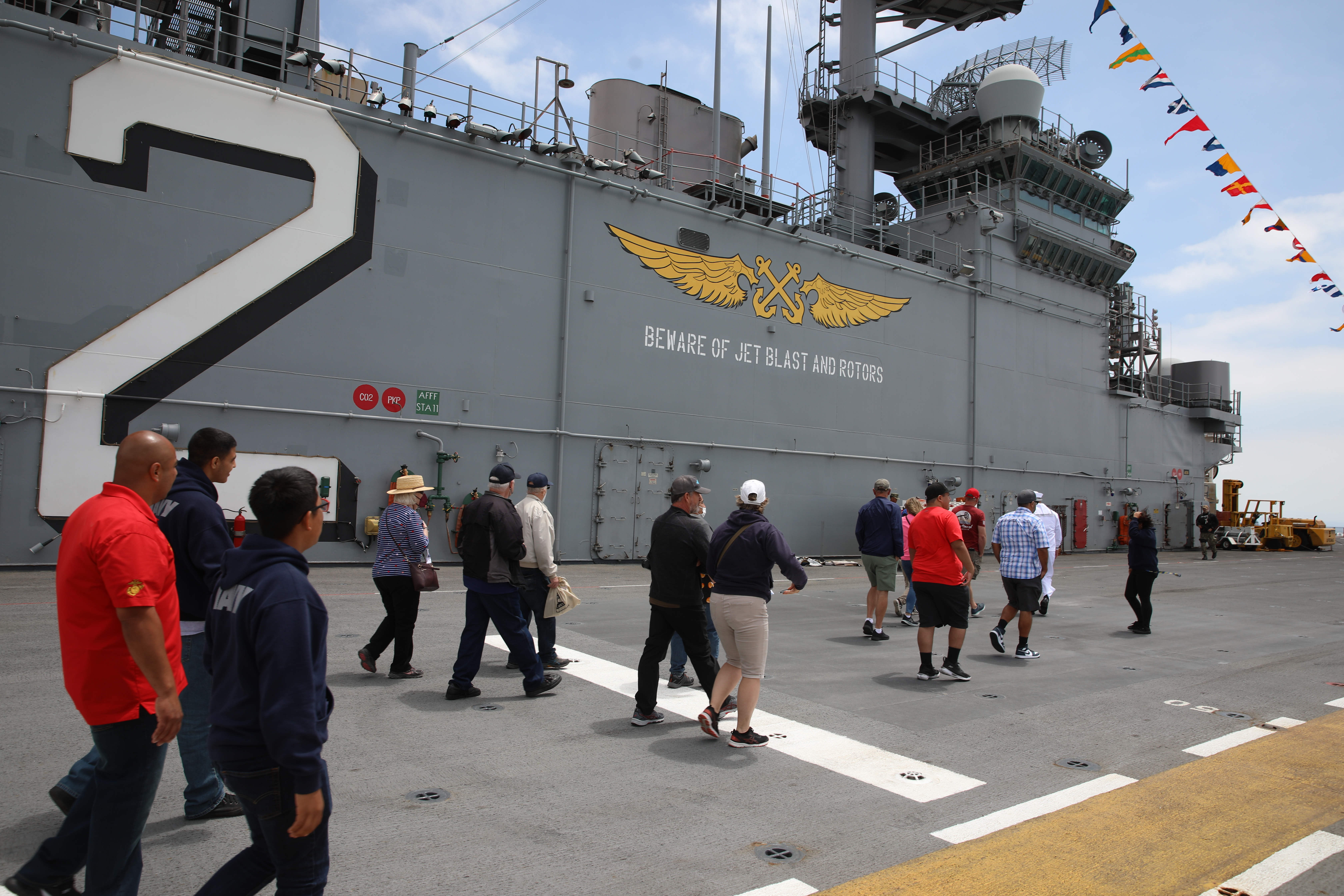 Visitors tour the flight deck of the USS Essex on...
