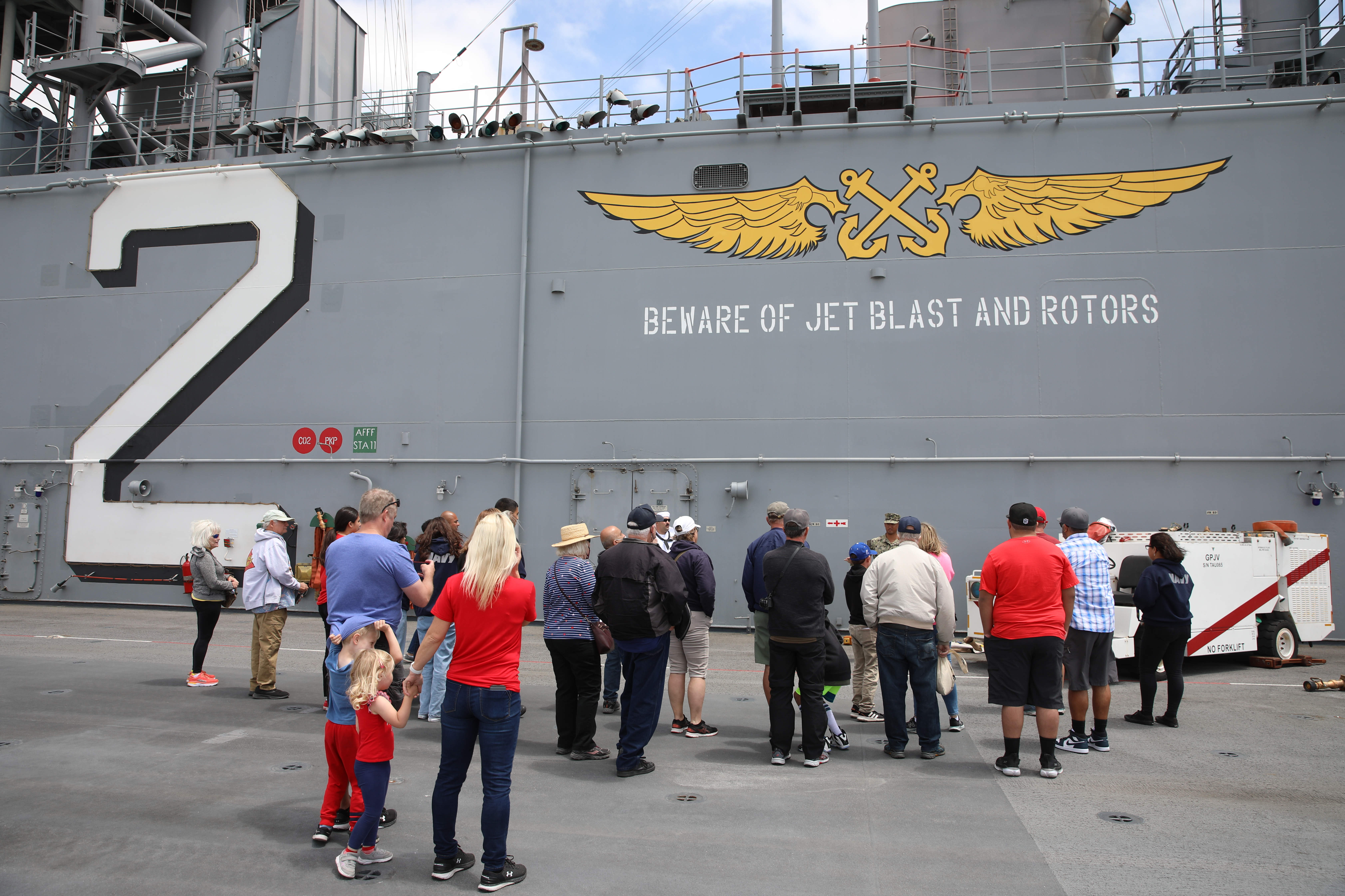 Visitors tour the flight deck of the USS Essex on...