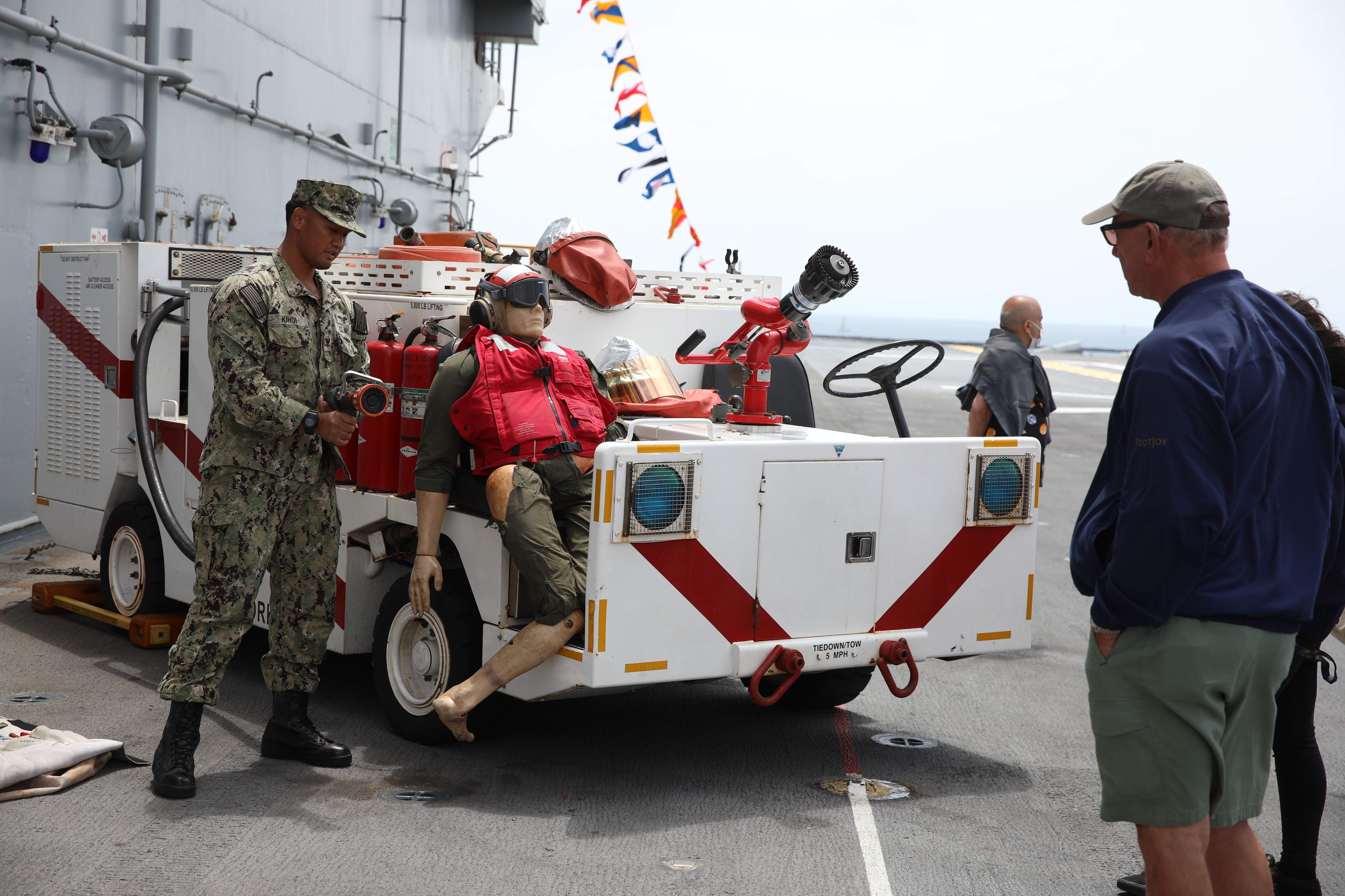 ABH3 Chad Kihoi goes over some of the firefighting equipment...