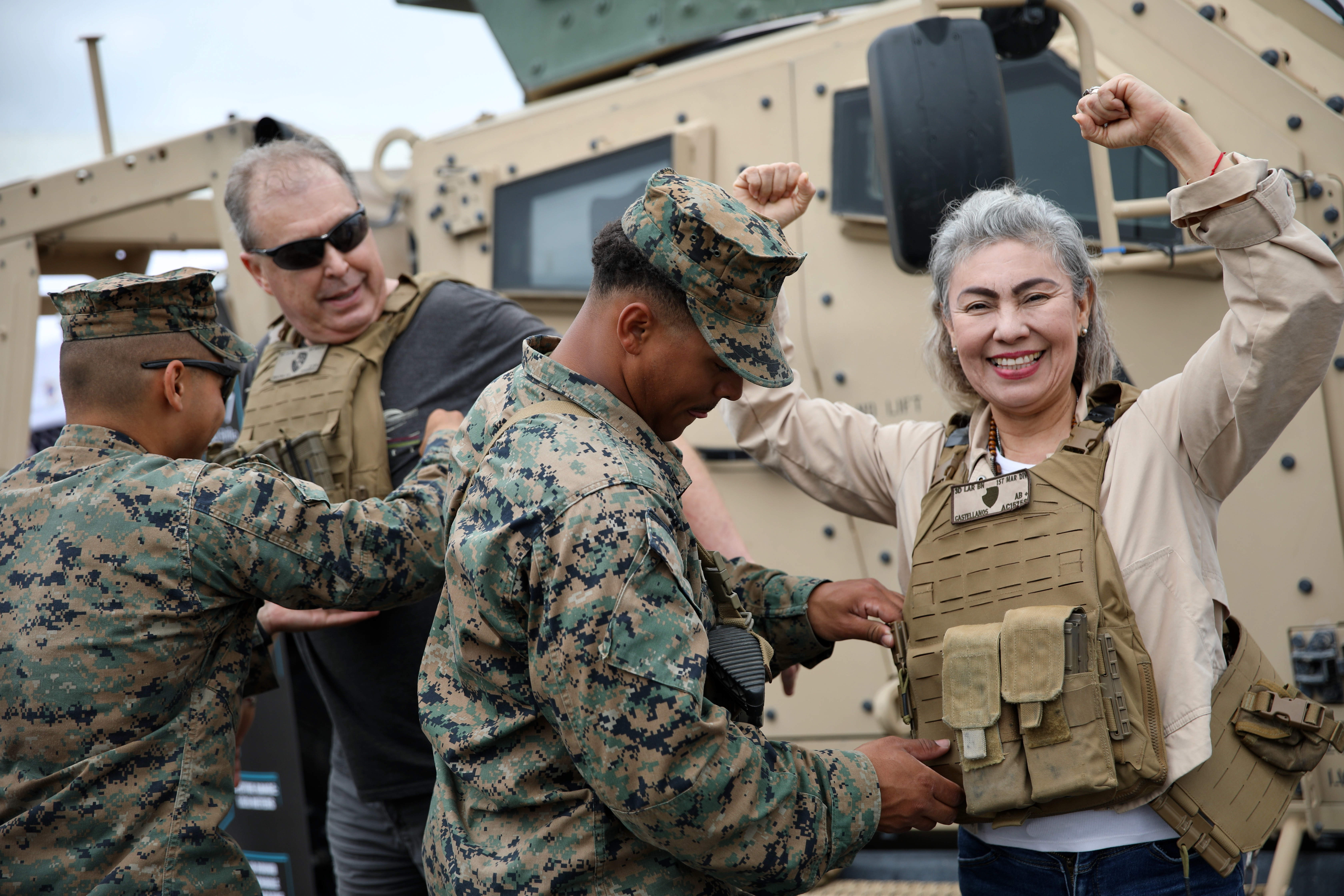Visitors learn about equipment as they interact with military personnel...