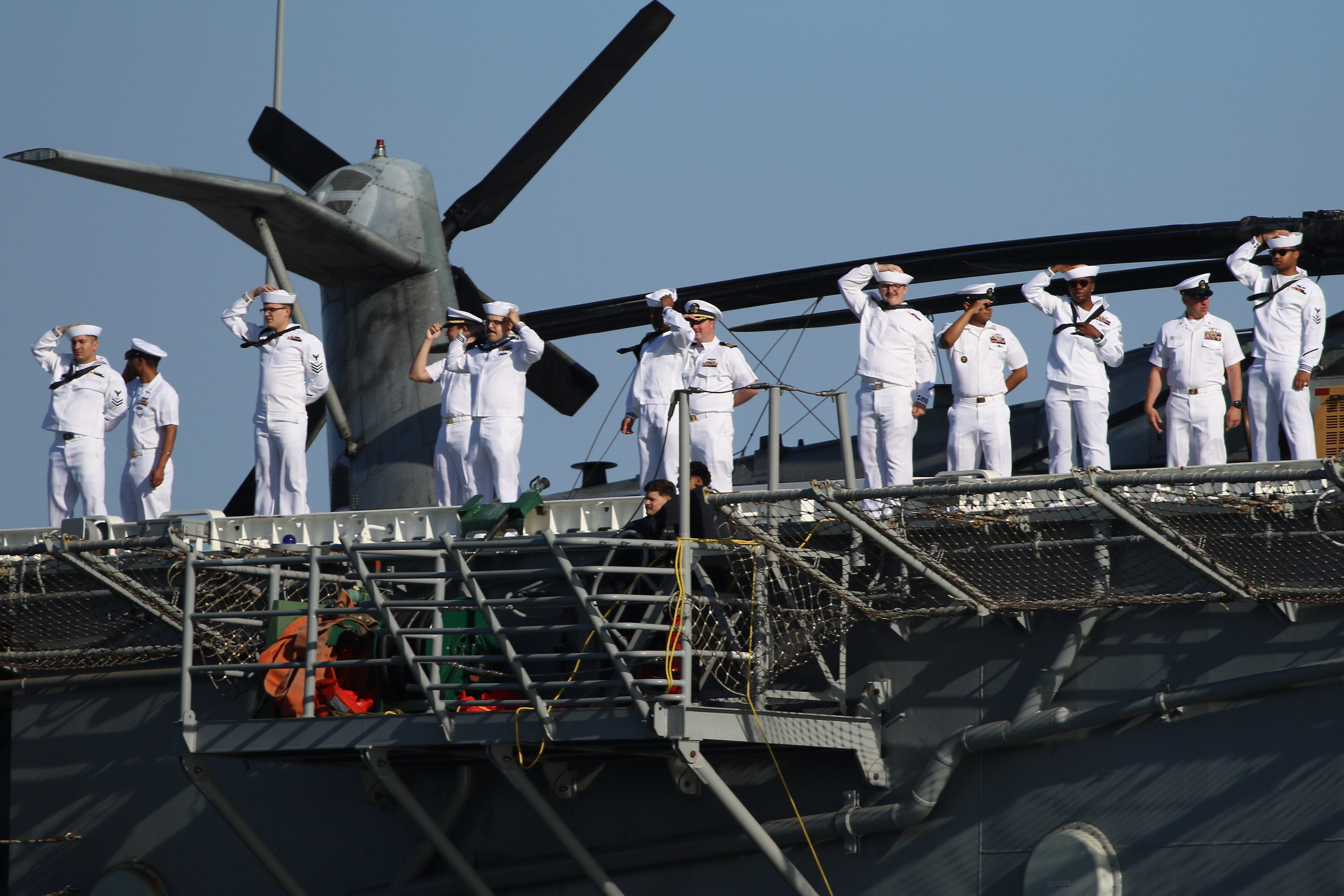 Sailors man the rails as the USS Essex arrives in...