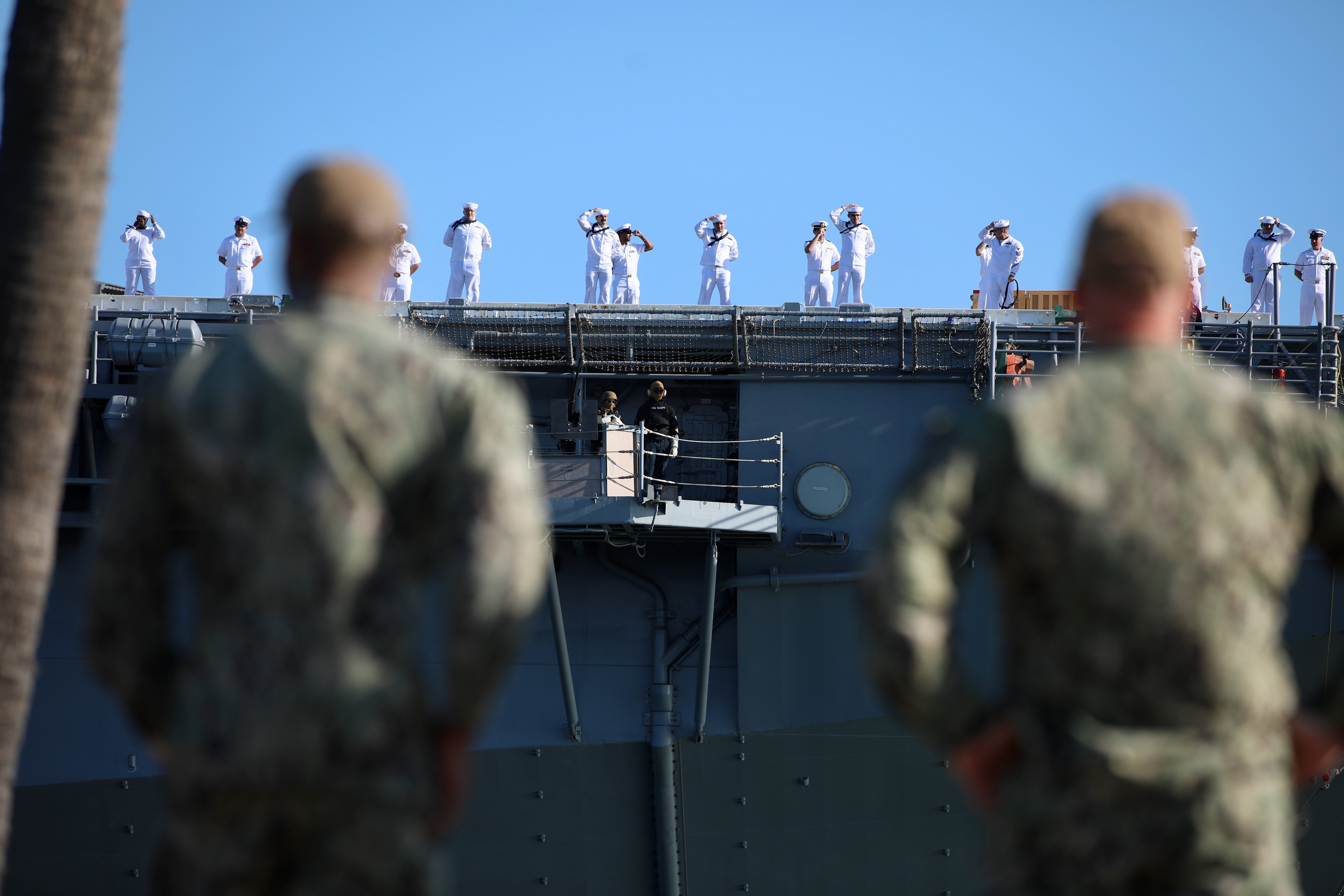 Sailors man the rails as the USS Essex arrives in...