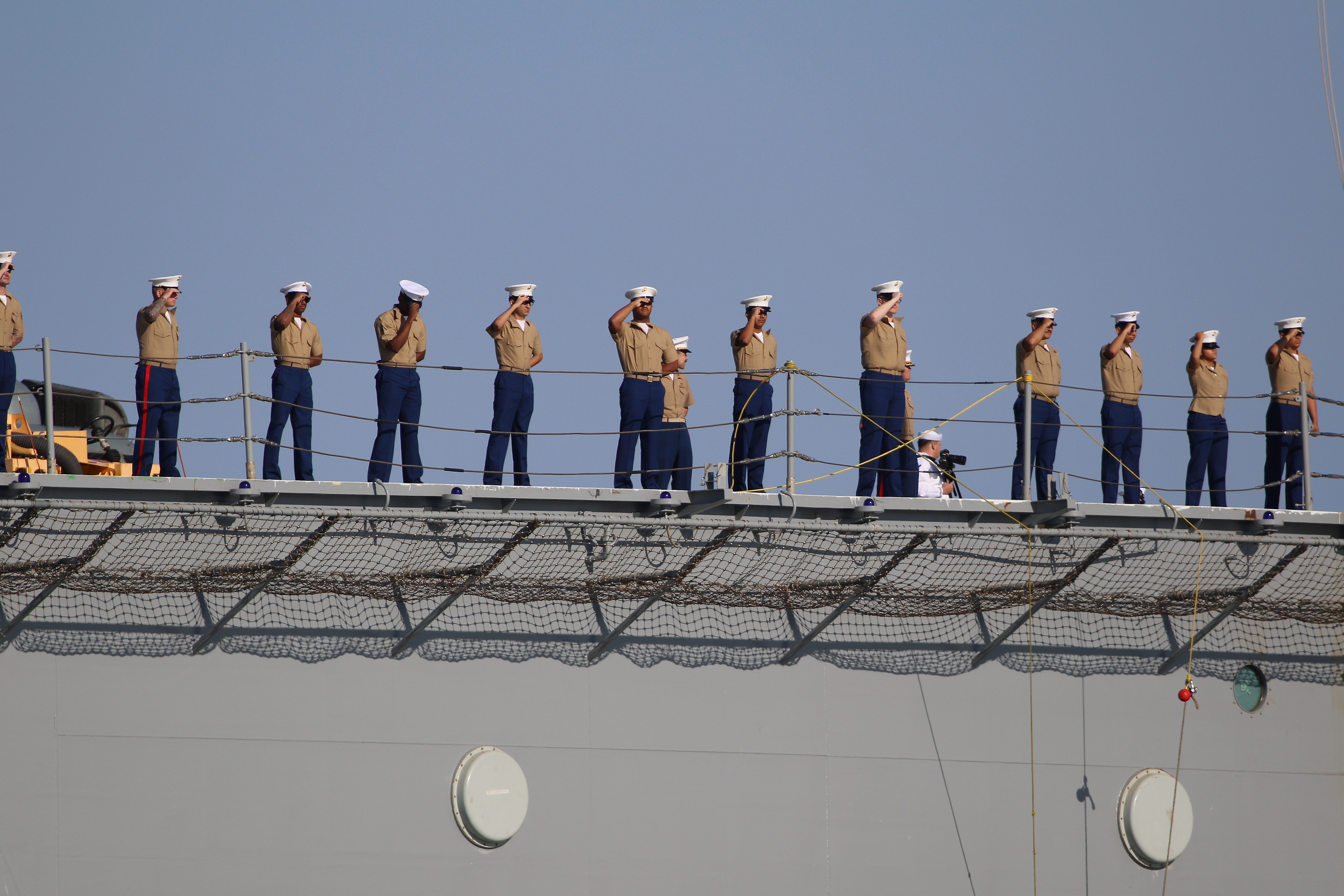 Sailors man the rails as the USS Essex arrives in...