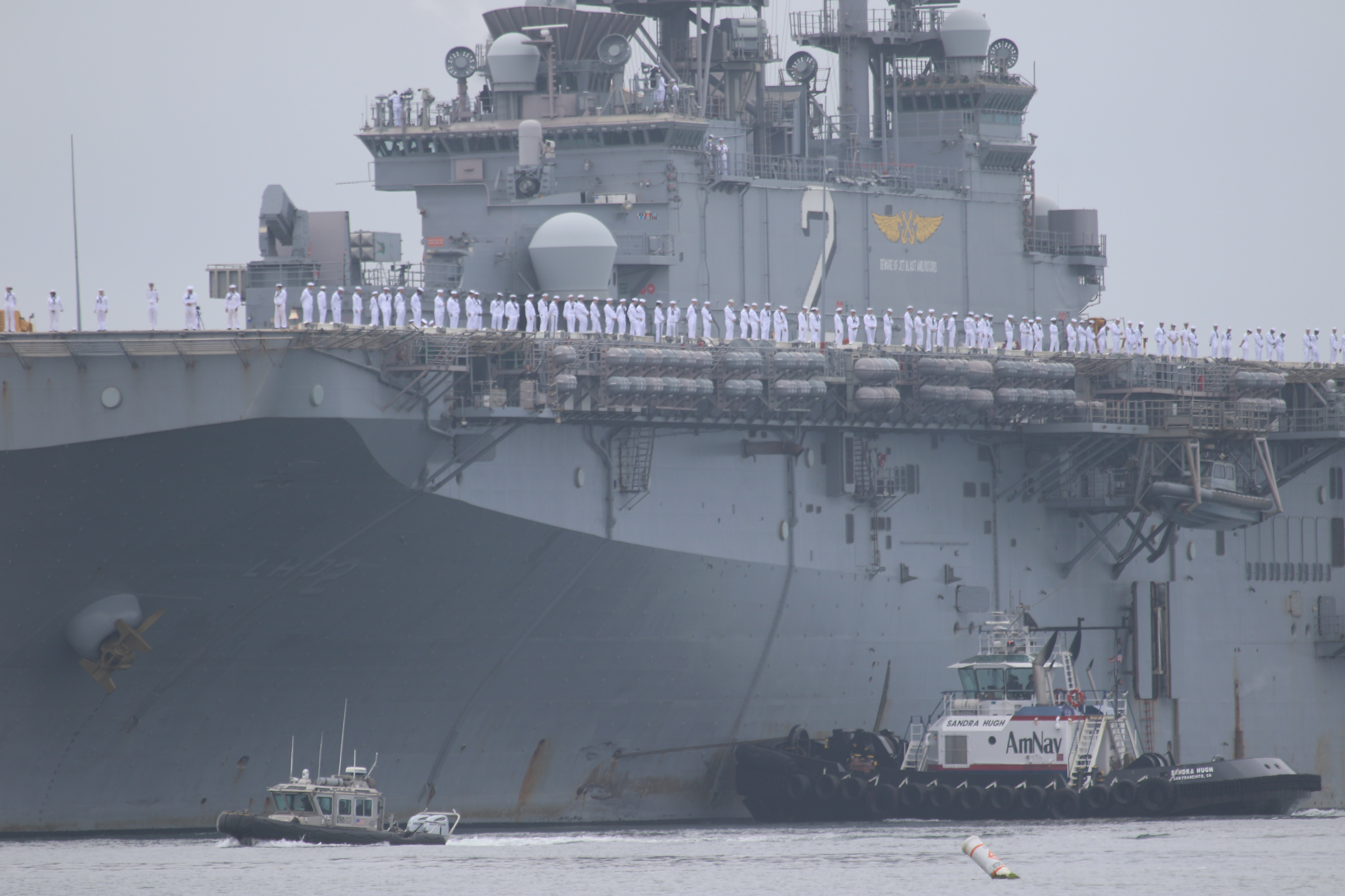 Sailors man the rails as the USS Essex arrives in...