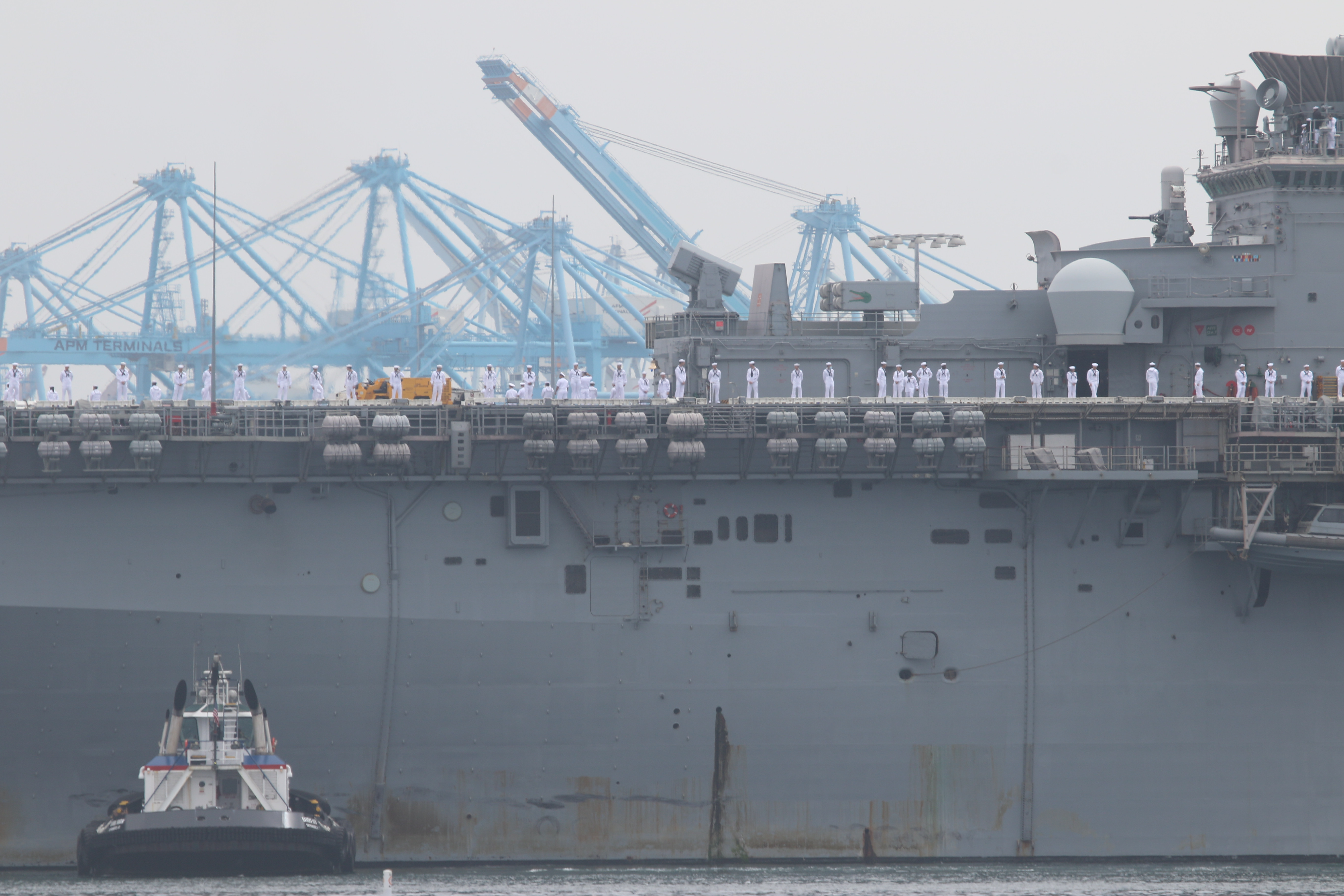 Sailors man the rails as the USS Essex arrives in...