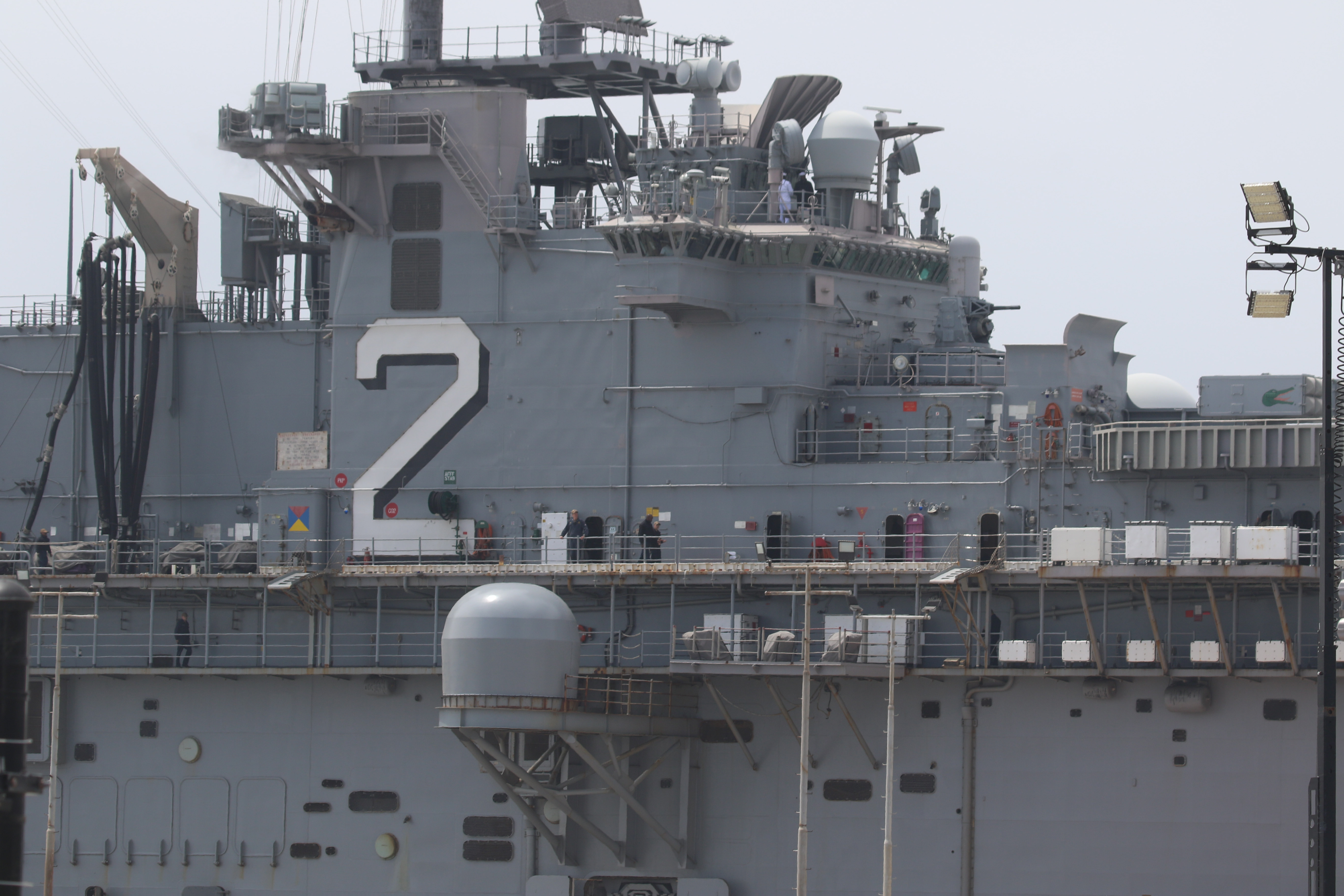 Sailors man the rails as the USS Essex arrives in...