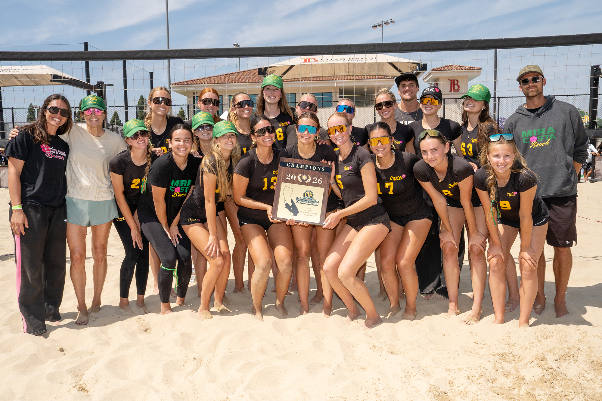 Mira Costa High School players and coaches pose with the...