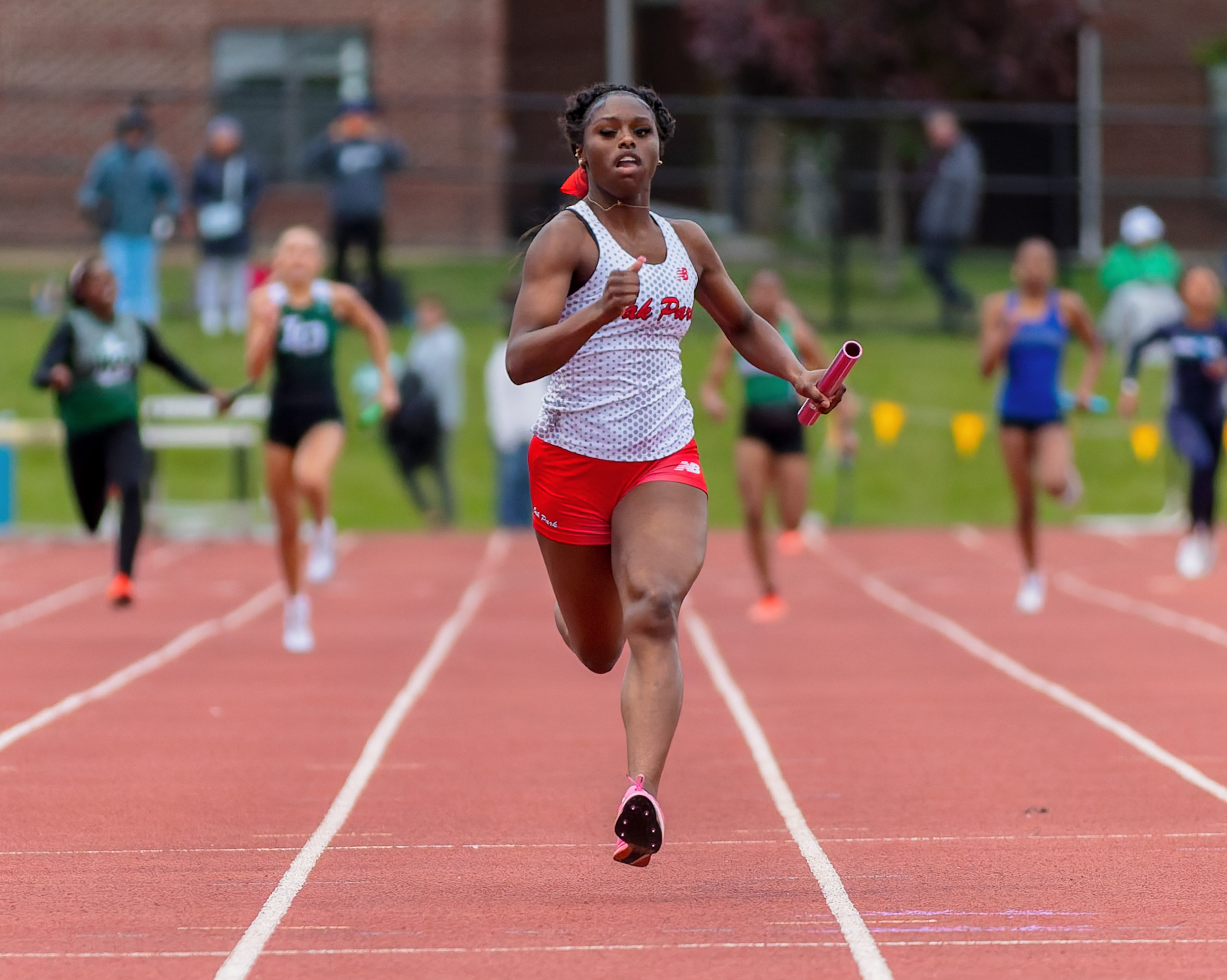 Oak Park's Aubrey Douglas finishes the girls 4x200m during the...