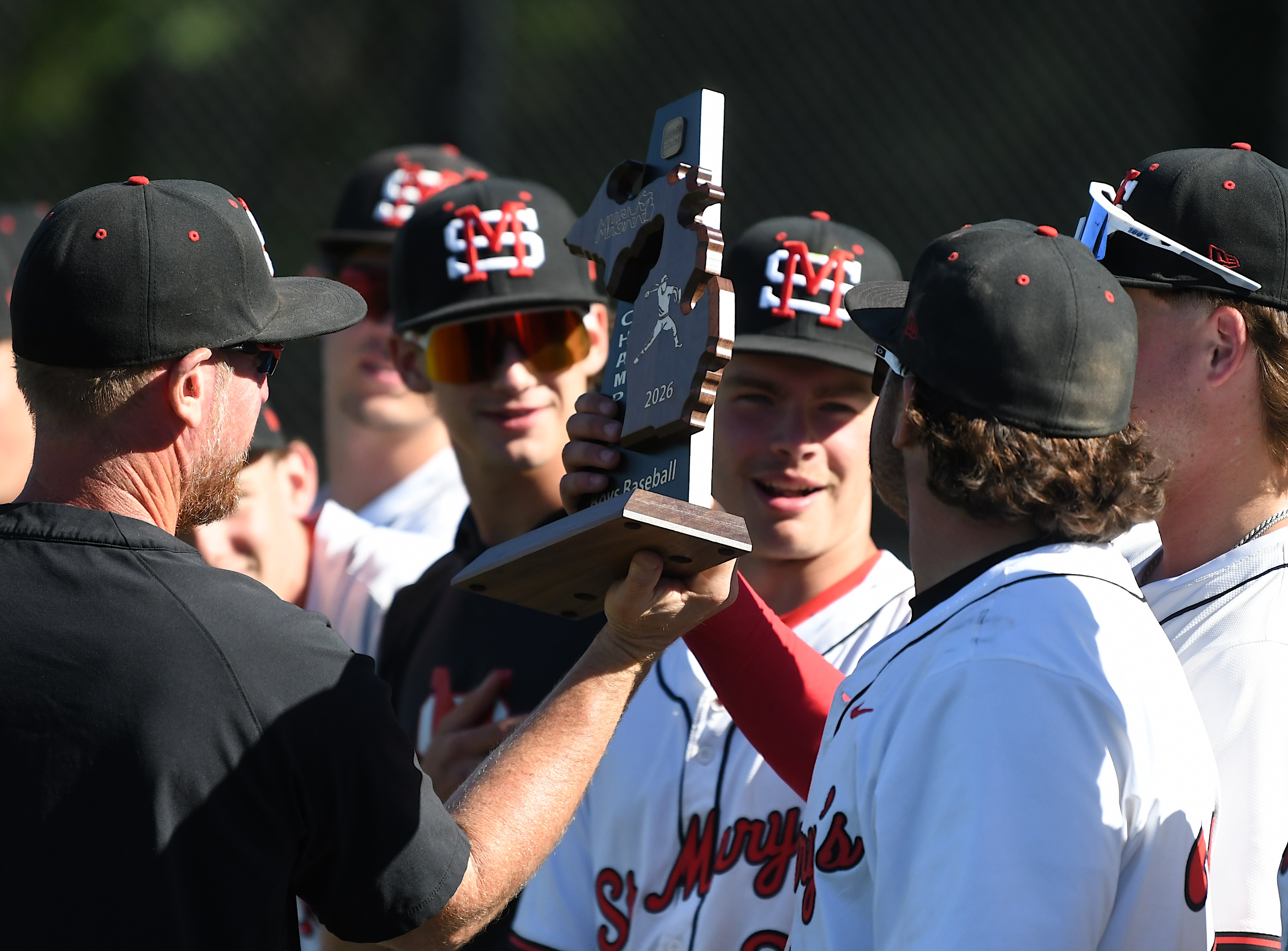 No. 1-ranked Orchard Lake St. Mary's players hoist the trophy...