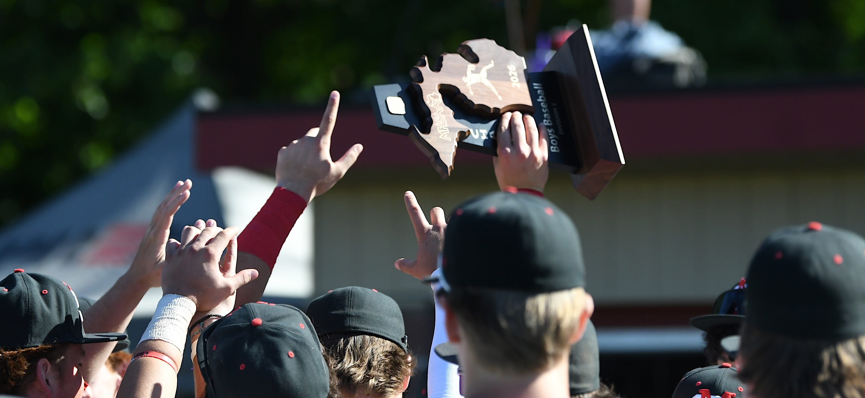 Orchard Lake St. Mary's players hoist the trophy after the...